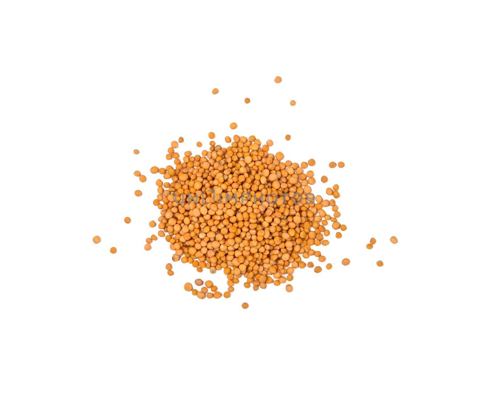 Close up one heap of wholegrain yellow mustard seeds spilled, isolated on white background, elevated top view, directly above