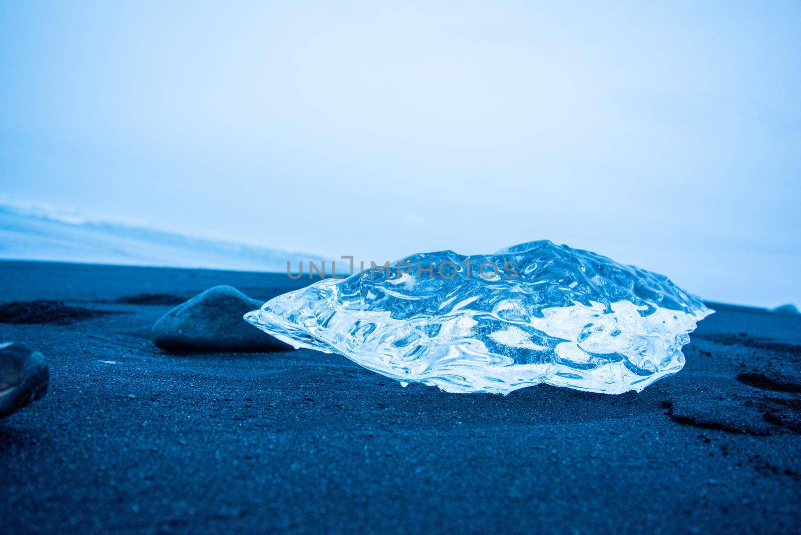 Close up of a piece of glacier beached in Iceland shiny beautiful magical diamond like crystal frozen