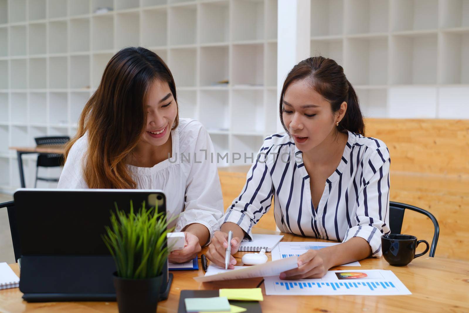 Group of Businesswoman and Accountant checking data document on paperwork for investigation of corruption account . Anti Bribery concept by itchaznong