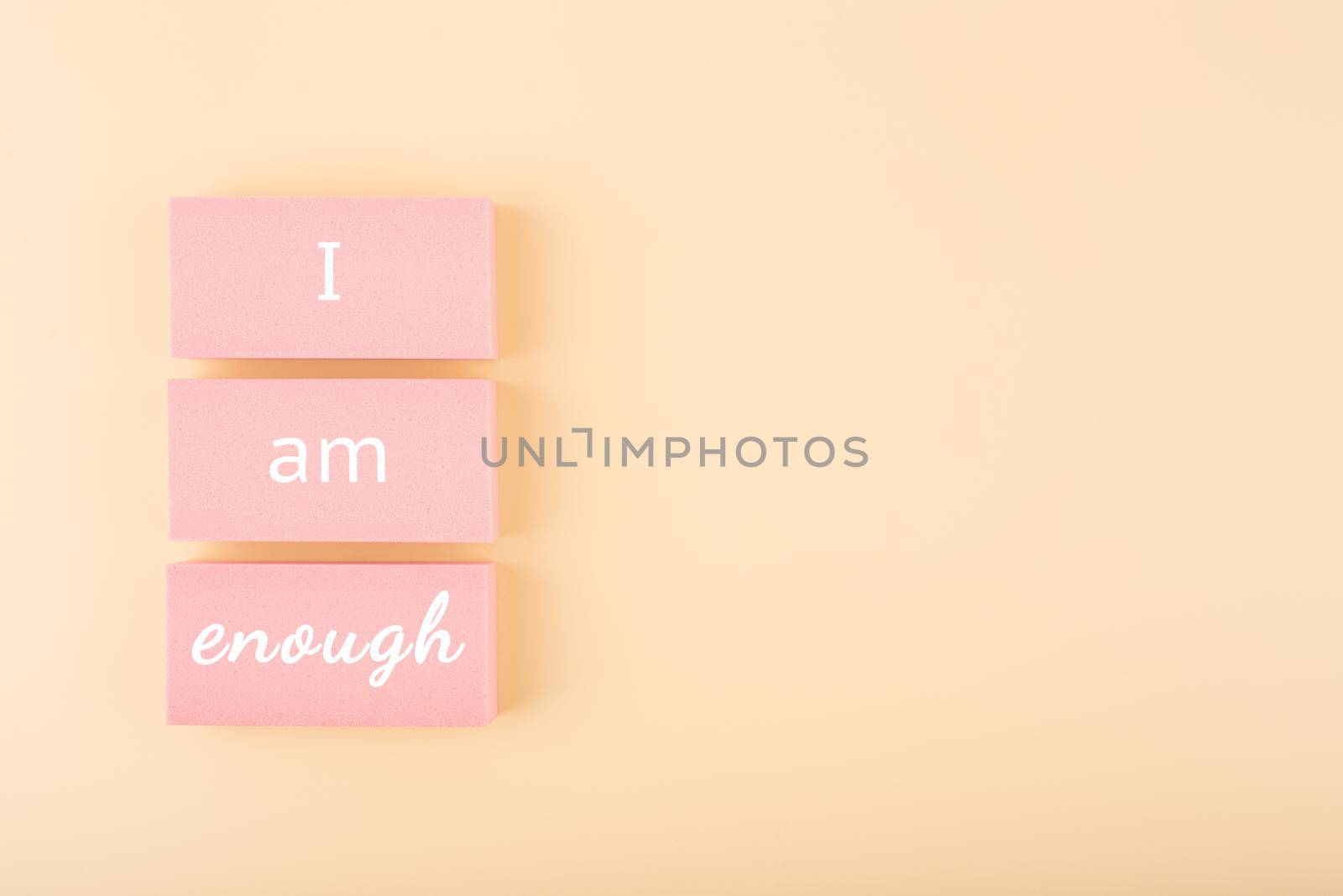 I am enough minimal concept on bright pastel beige background with copy space. Mental health and self love concept