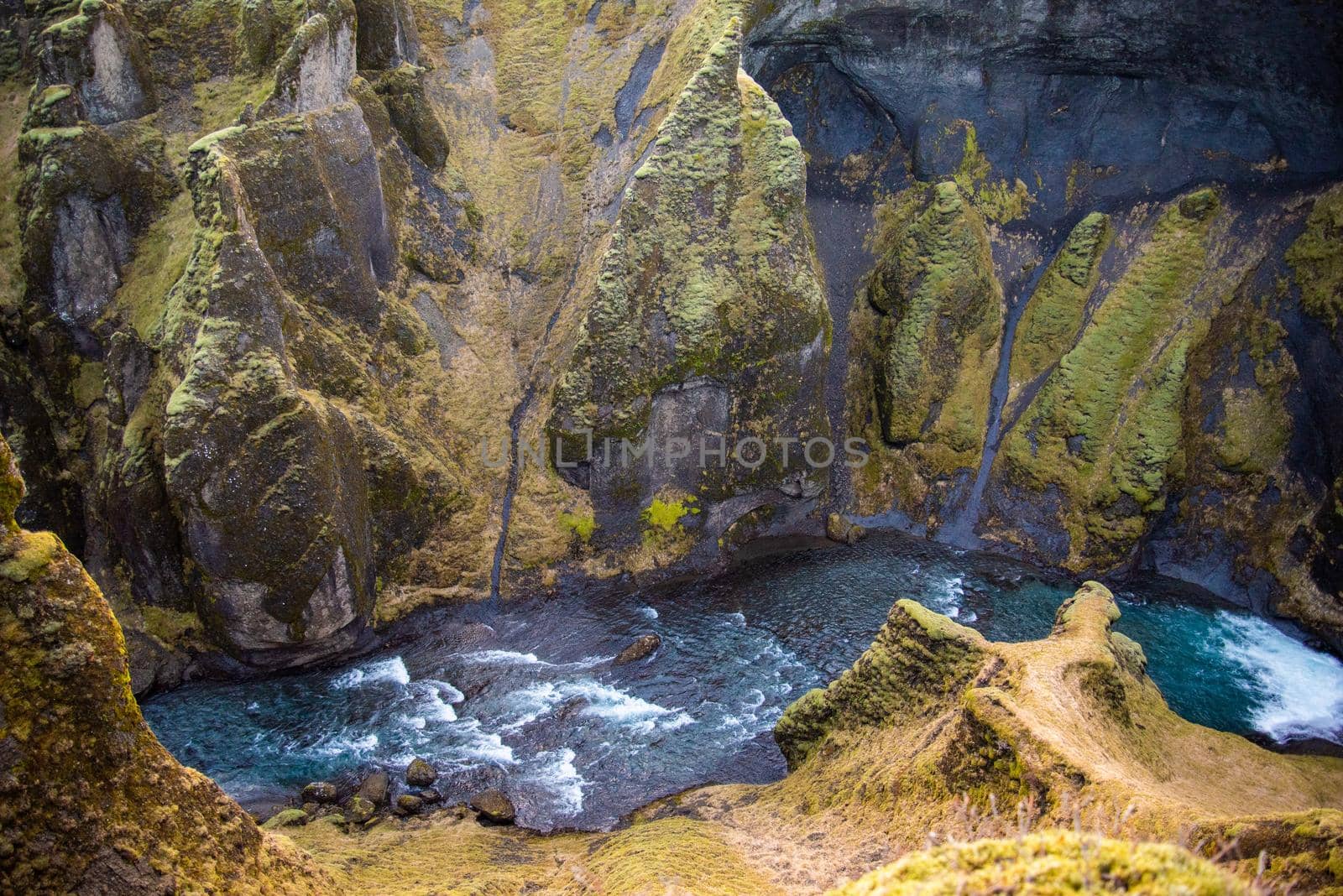 Iceland mossy green canyon with breathtaking views. Closeup of the river from the top. by jyurinko