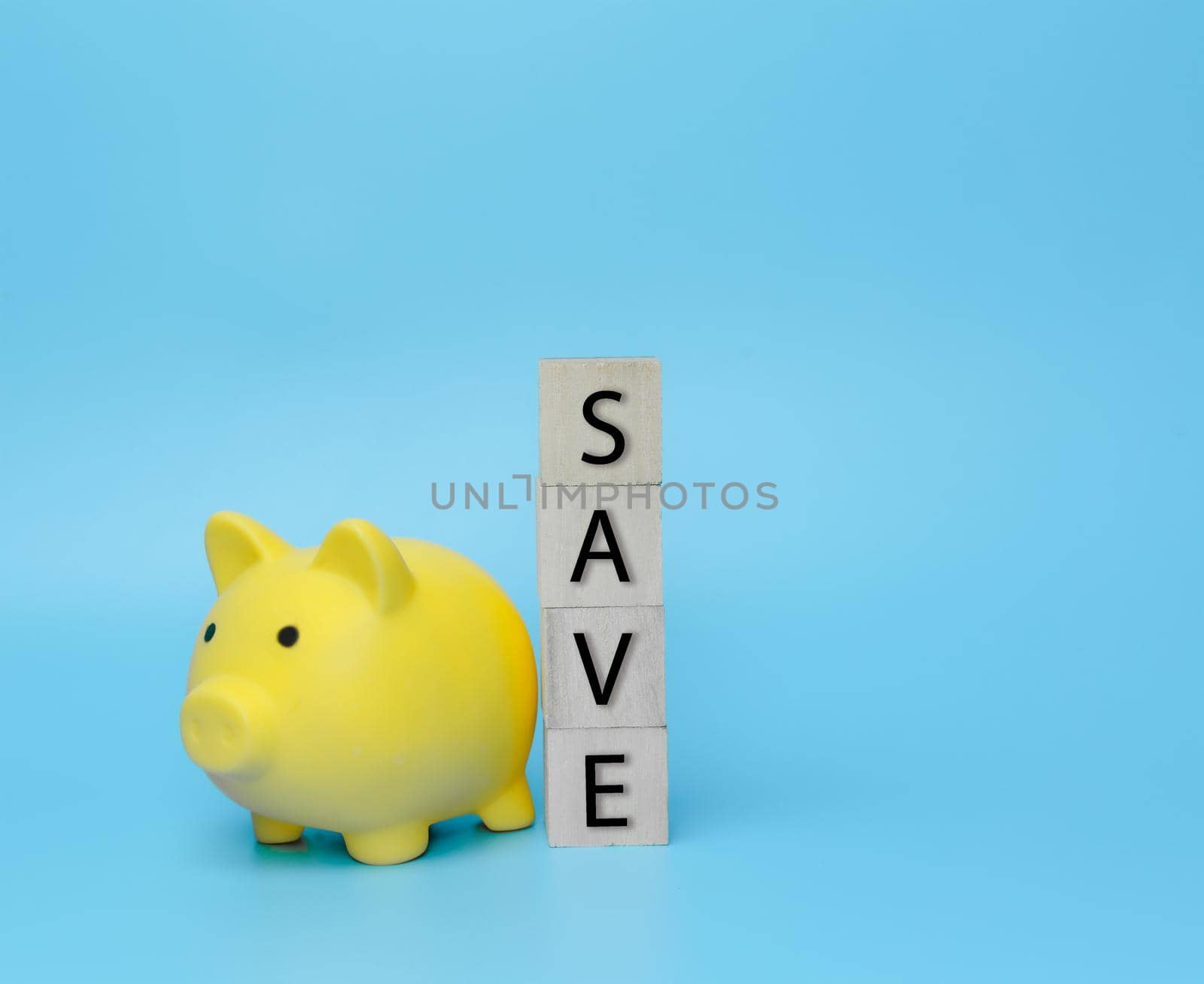 Save money in piggy bank on blue background