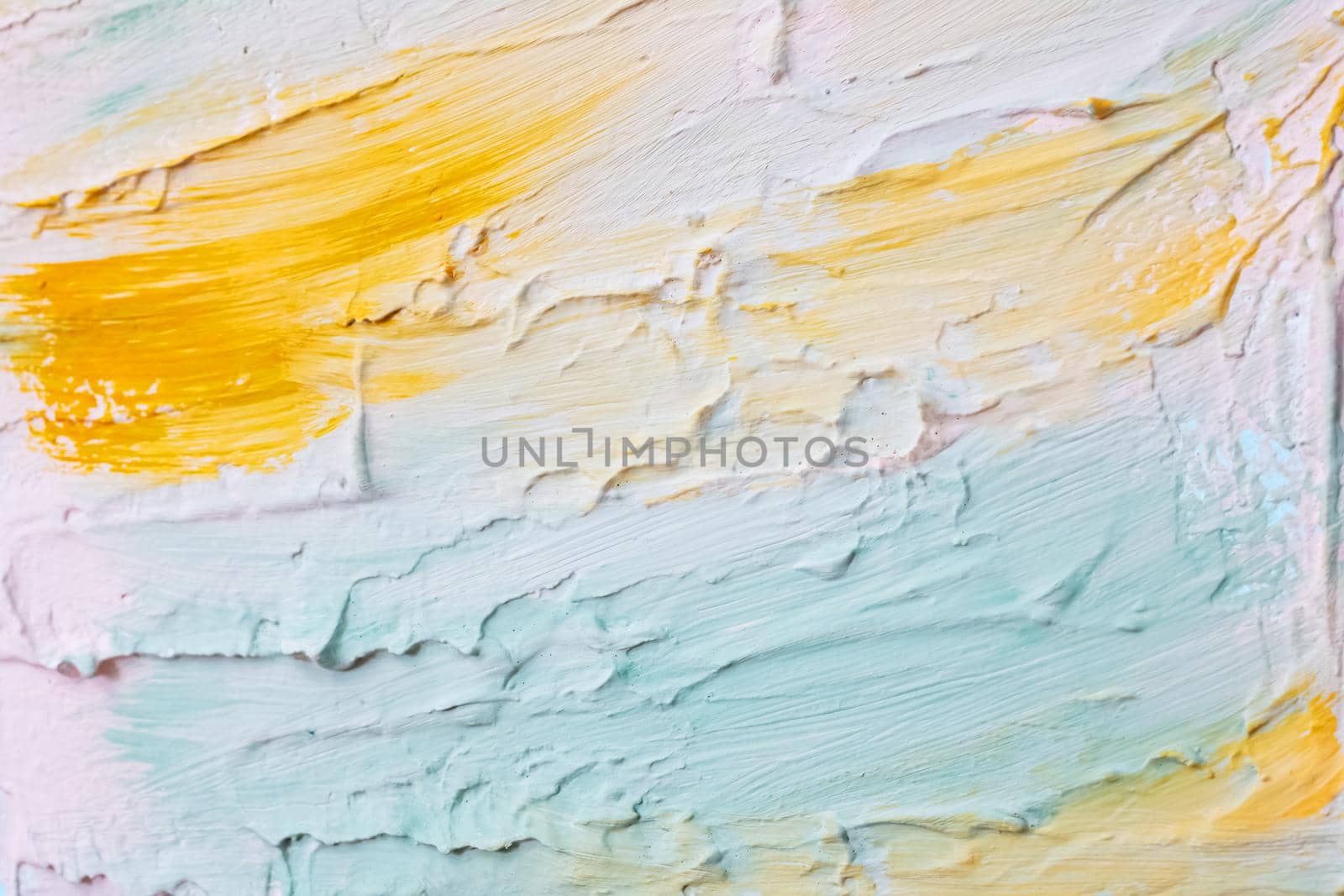 Smears of blue, yellow and white paints on the wall, background or texture