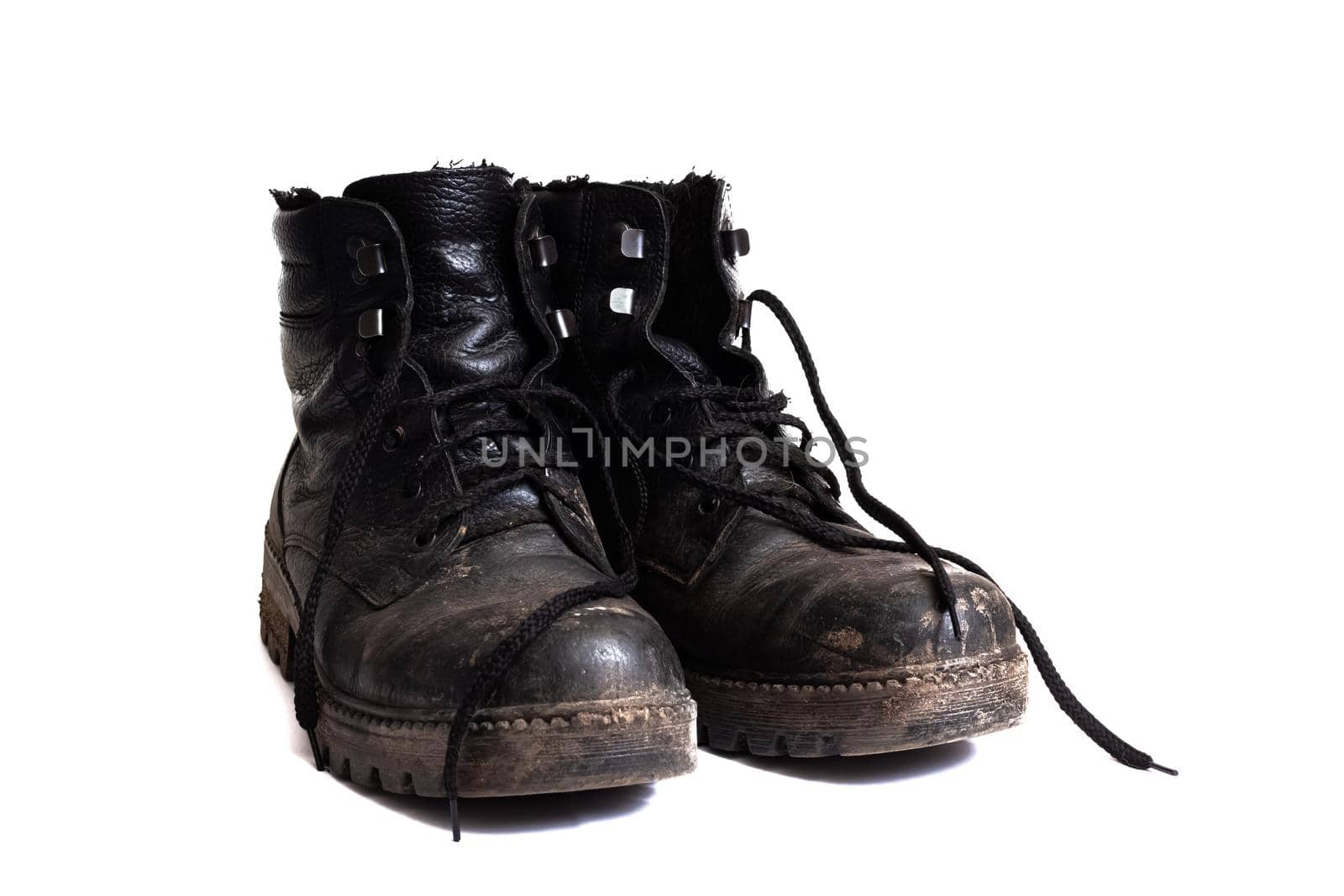 Black dirty men's boots isolated on a white background