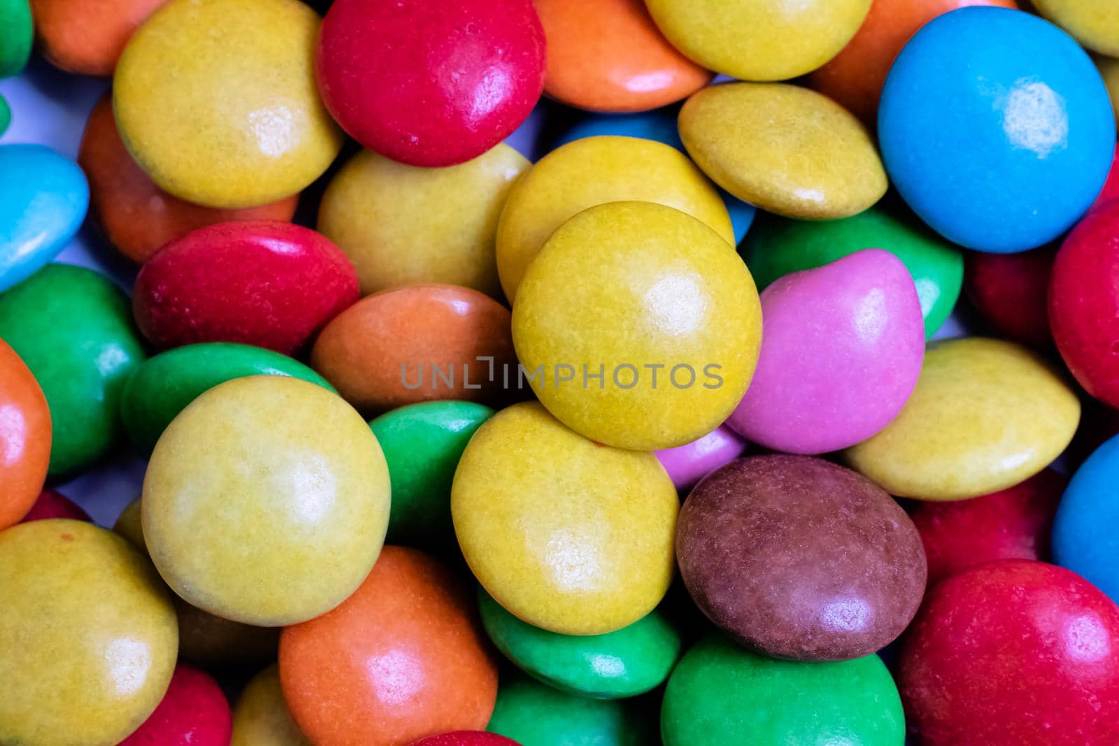 Pile of multicolored candies close up, background or texture