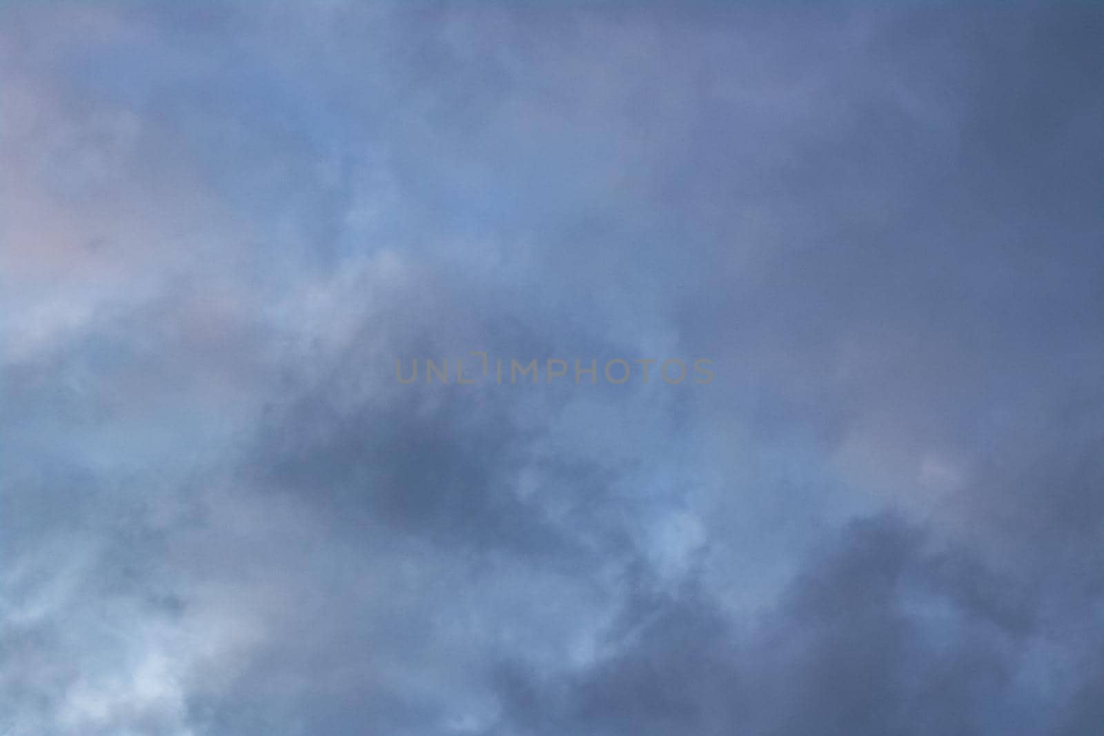 Evening sky with blue clouds close up, blurred background
