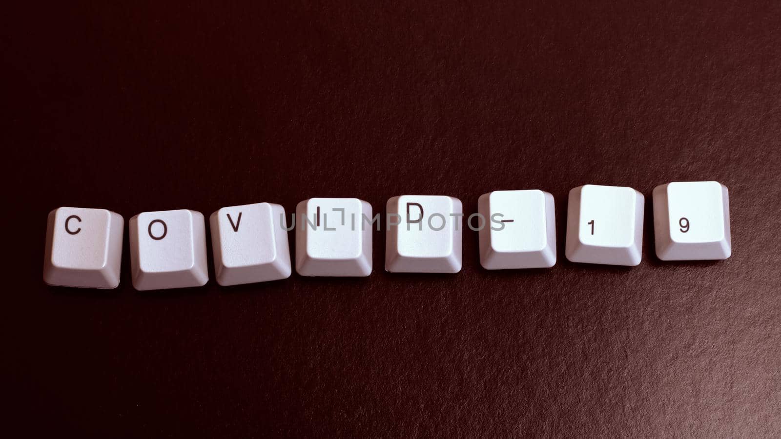 The word Covid-19 from the keyboard keys on red background