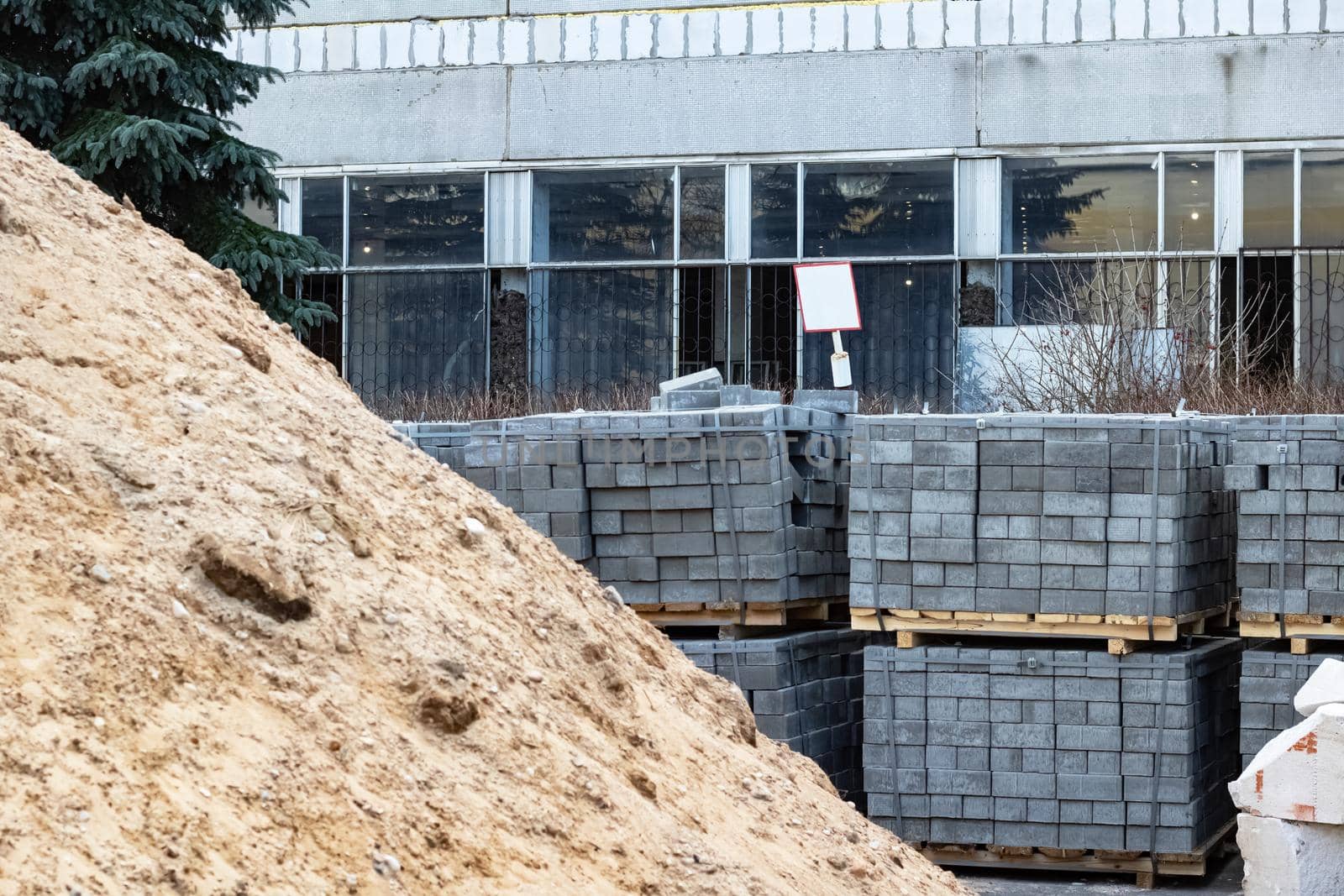 Pile of sand and paving slabs at a construction site