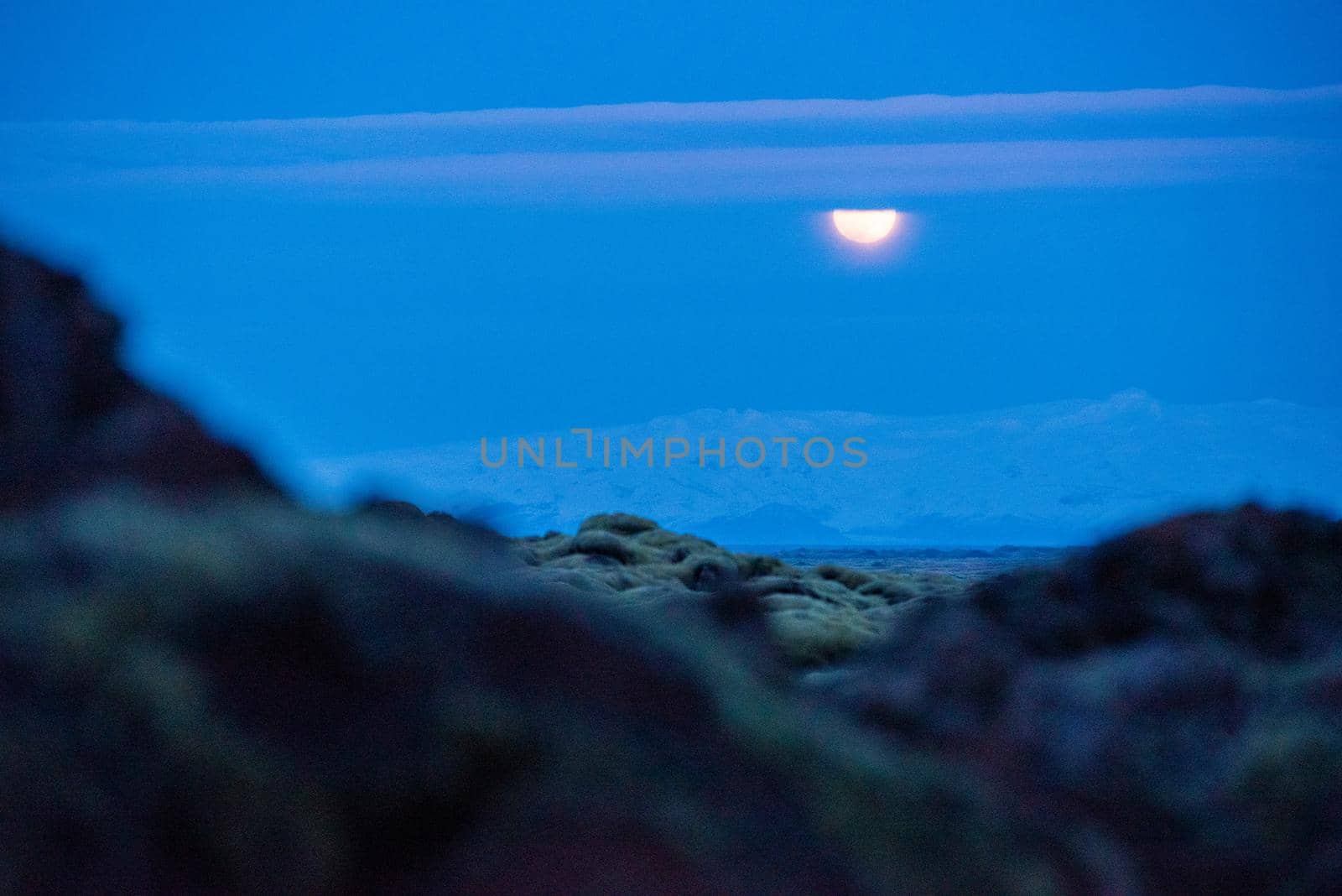 Full moon rising over a glacier in Iceland by jyurinko