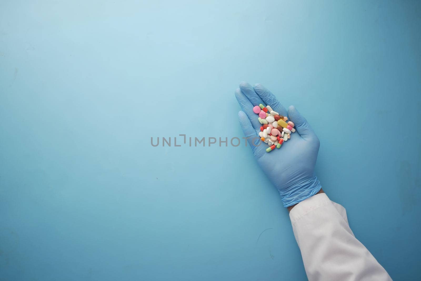 doctor holding medical pill on palm of hand .