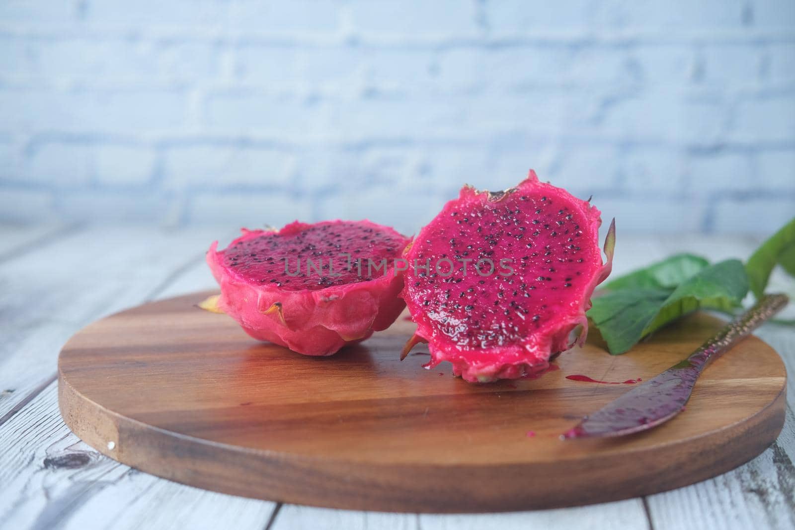 slice of dragon fruit on a chopping board.,