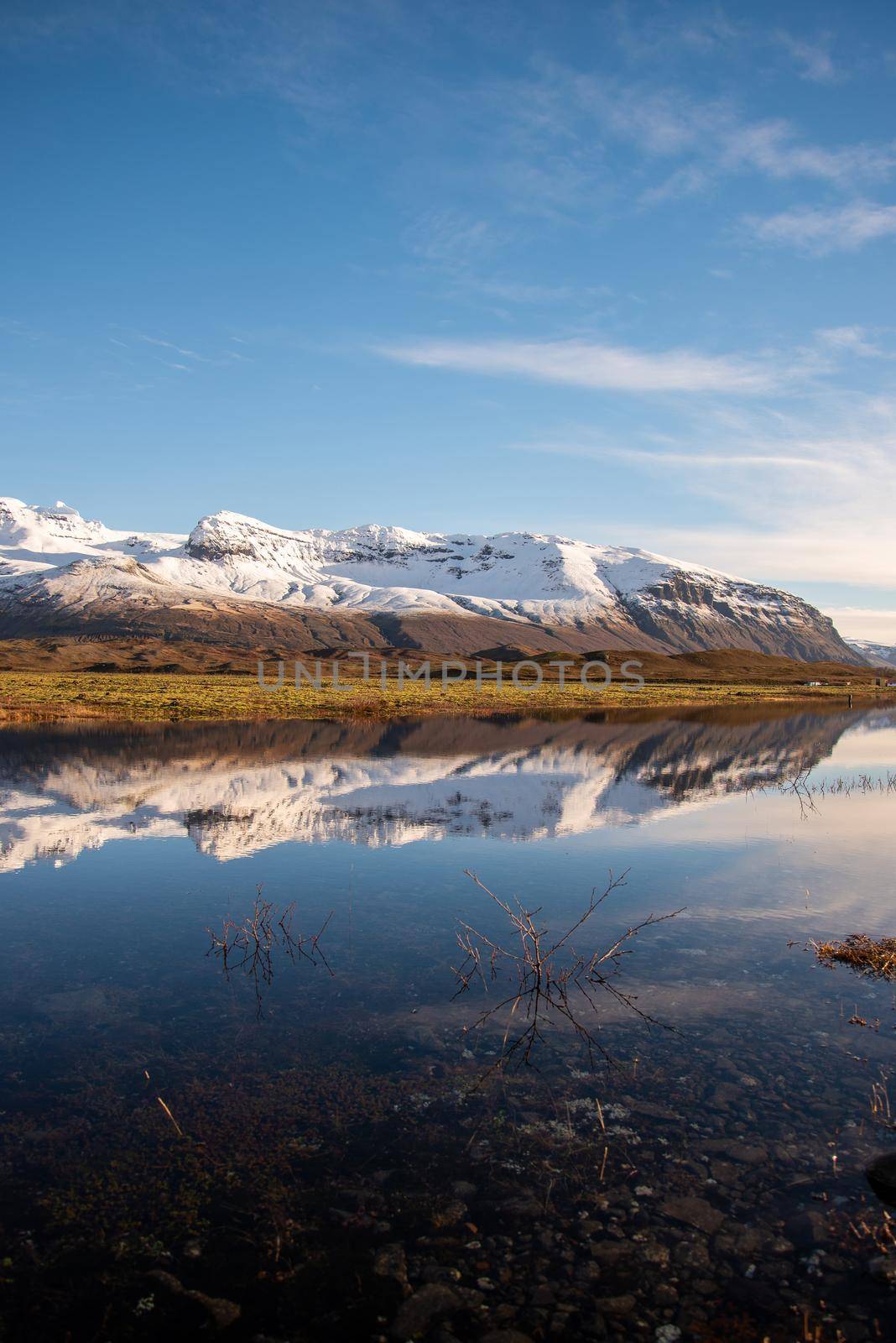 Vertical crop Icelandic mountain range with beautiful snowcapped mountains by jyurinko