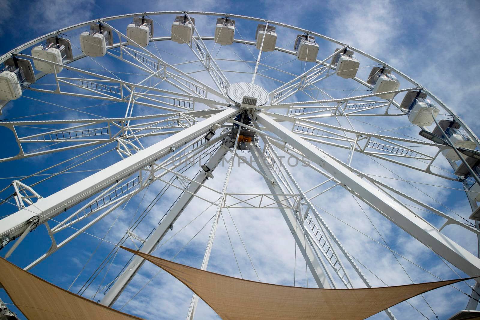 Photo shoot of a white ferris wheel with blue sky background 