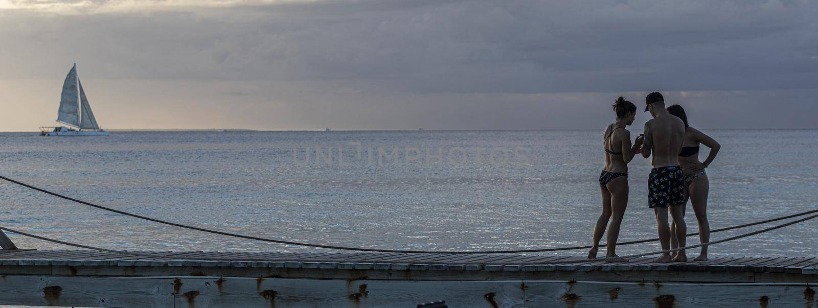 Friends on sunset pier vacation by pippocarlot