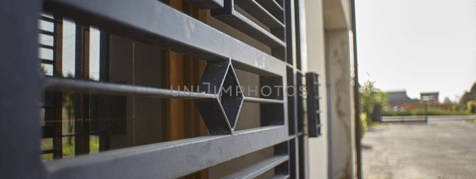 Armored door in artisan iron used for security reasons to protect a home, banner image with copy space