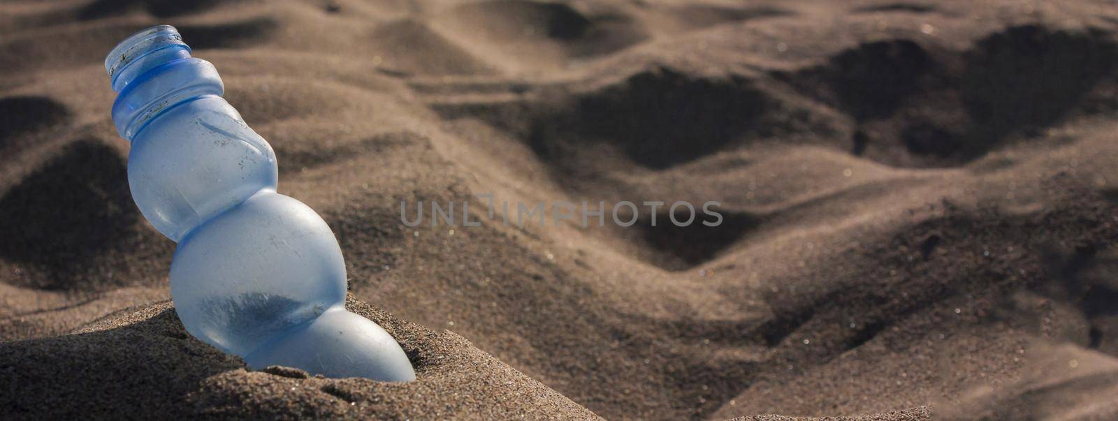 Plastic pollutes beach, banner image with copy space