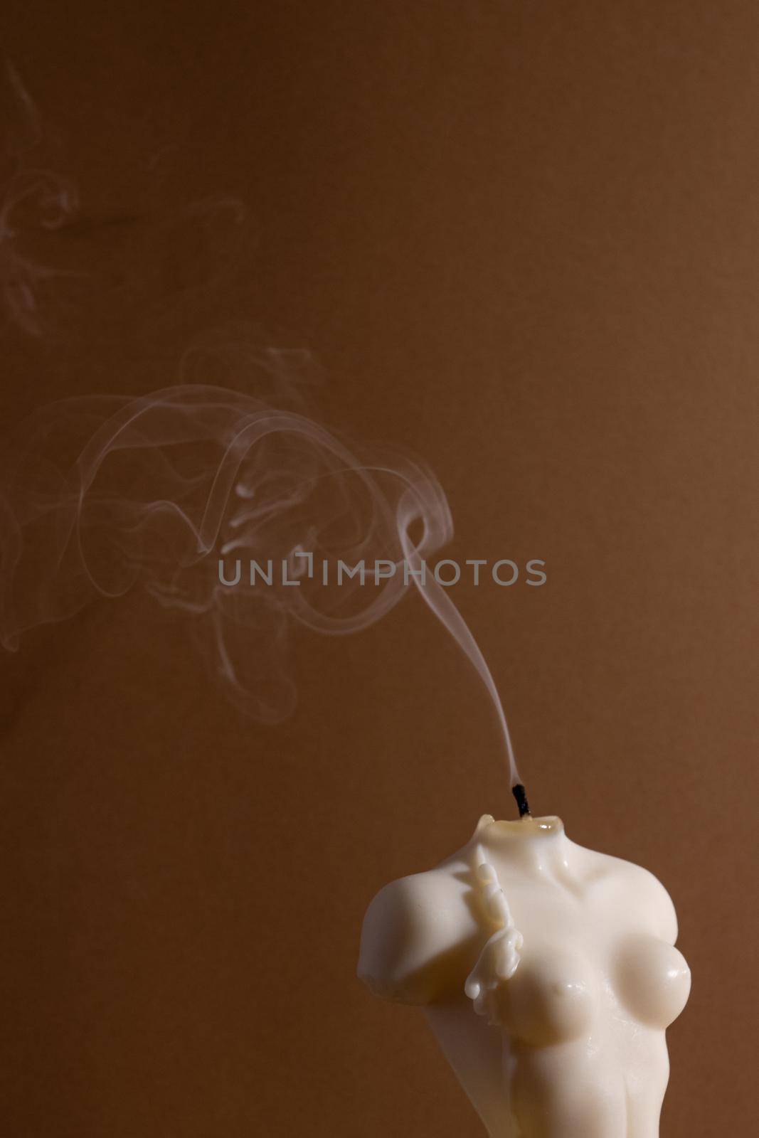 Candle in woman torso shape burning in brown interior , atmosphere and smoke after candle by katrinaera