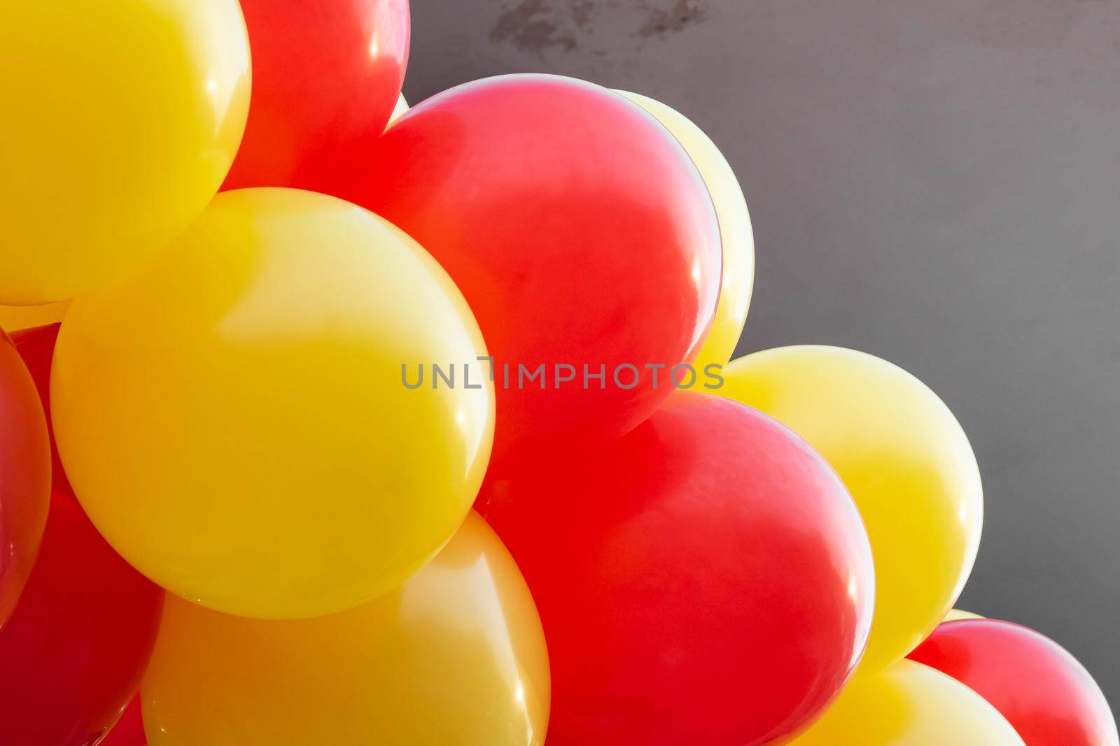 Yellow and red balloons on the building close up