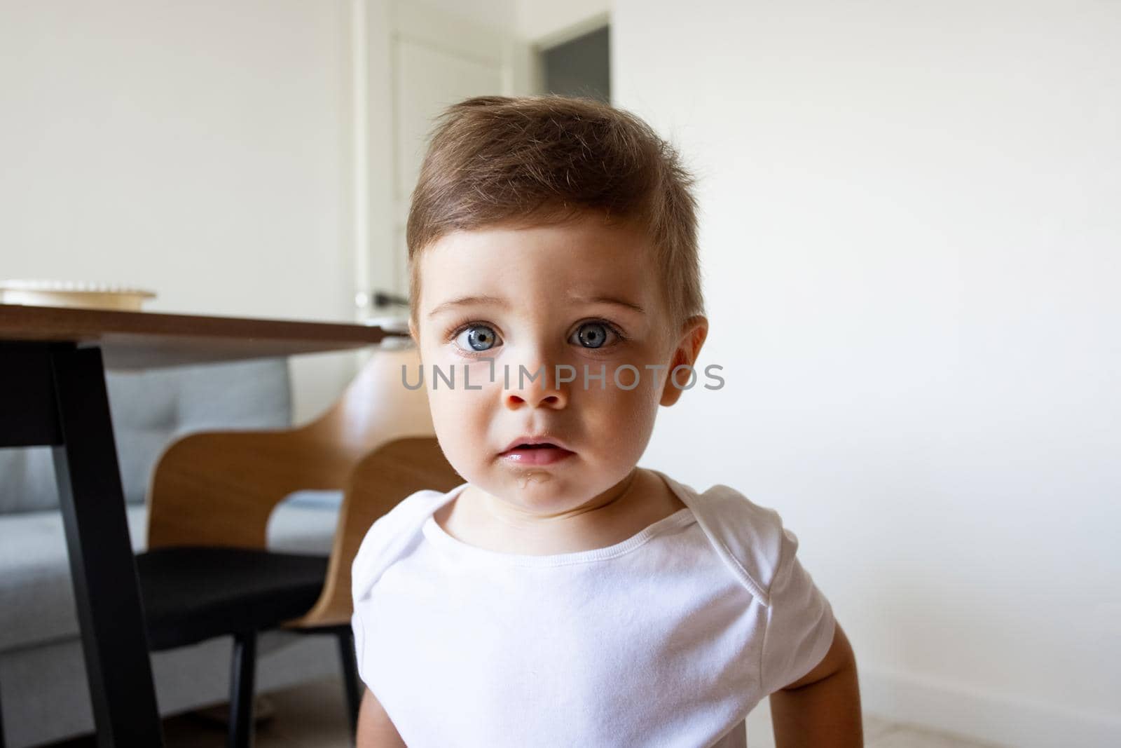 Adorable toddler baby boy (1-year-old) waiting for food at home .Children's closeup portrait of activity and baby lifestyle concept by katrinaera