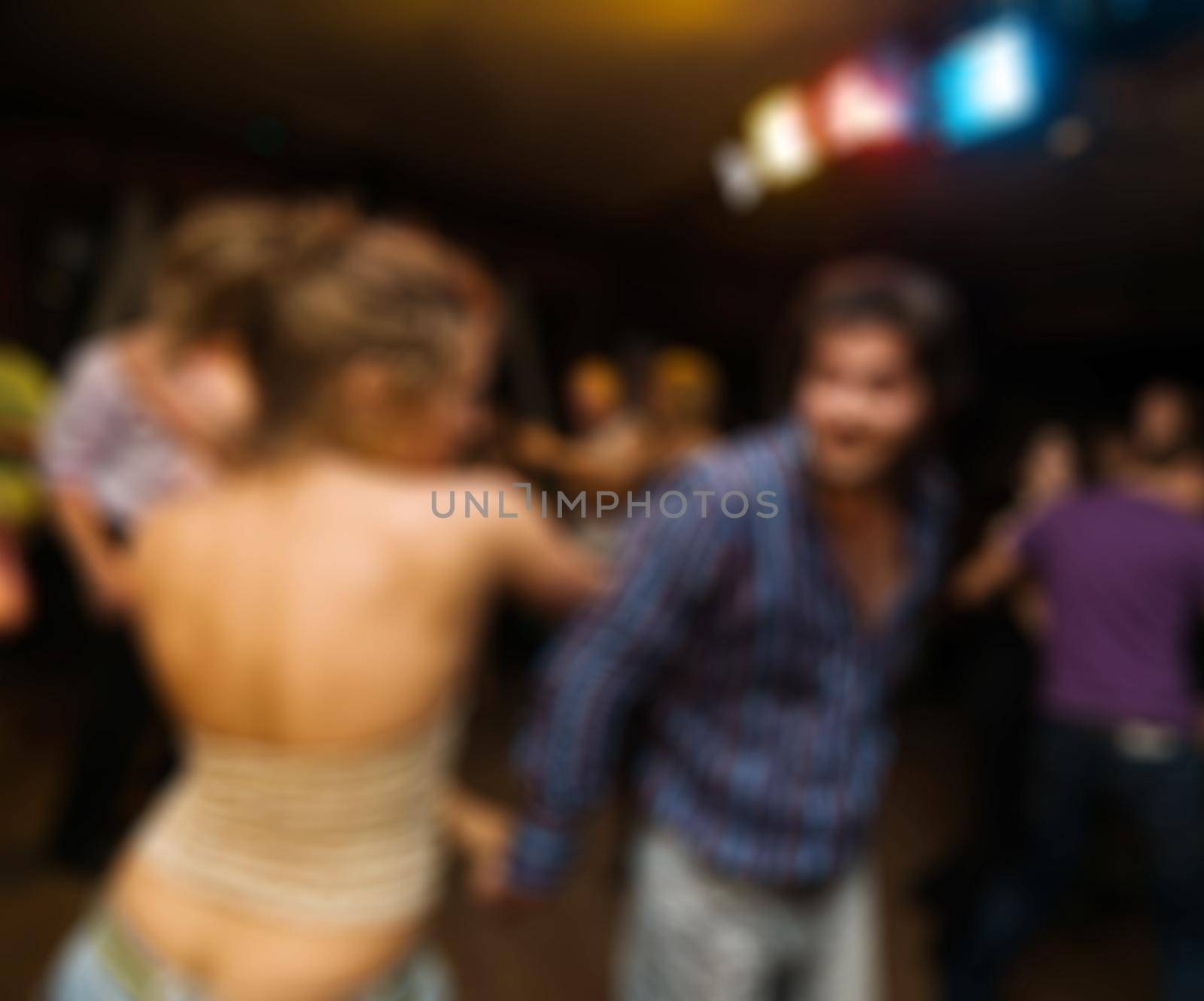 People dancing at the party abstract blur background with bokeh