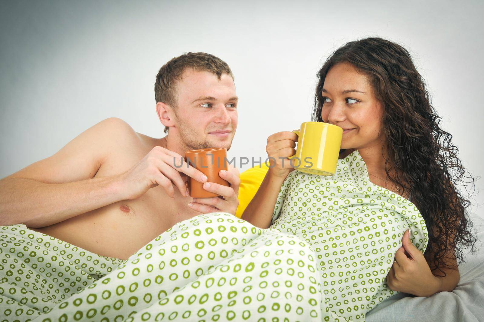 Happy young couple in bed