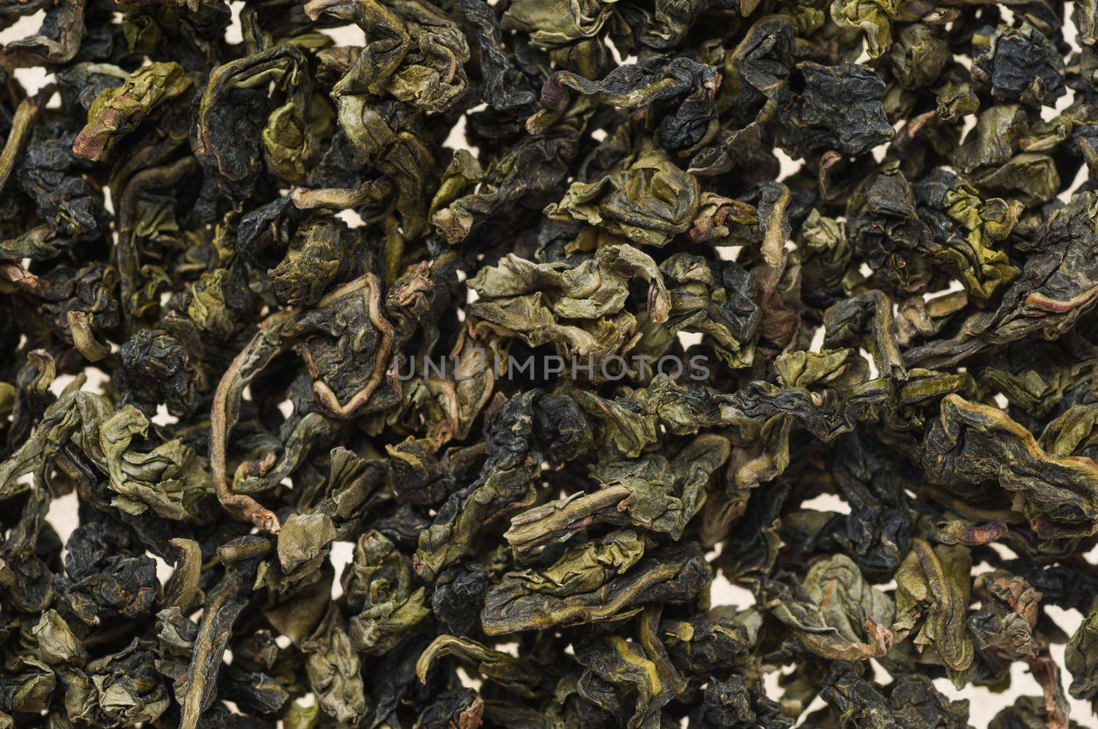 Heap of dry chinese green tea - background texture. Macro shot