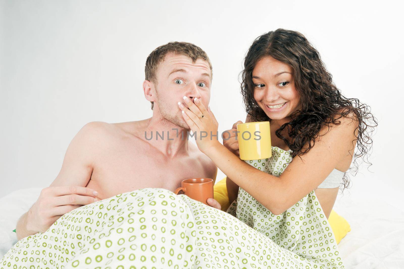 Young caucasian heterosexual couple in bed at home