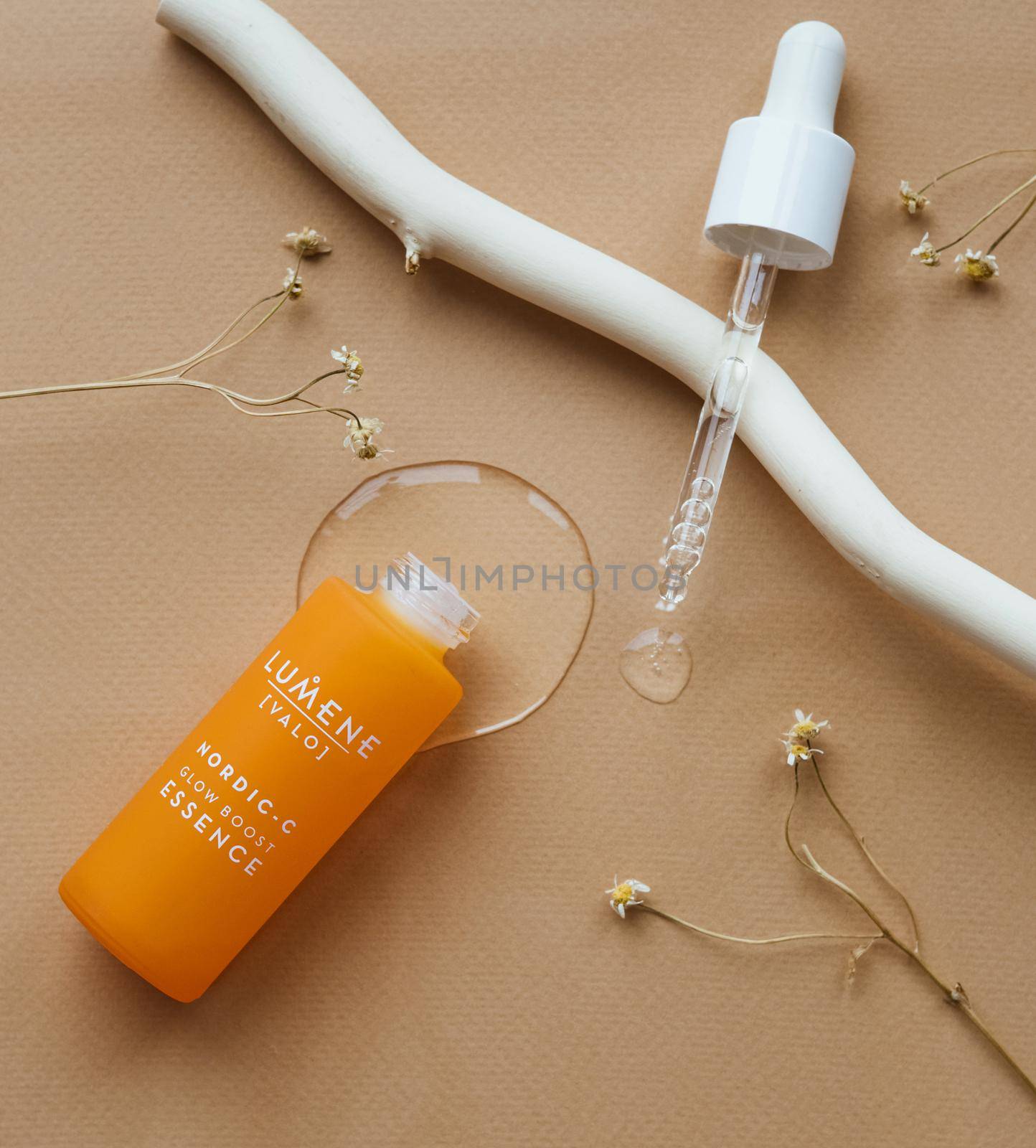 Moscow, Russia 08.10.2021 Lumene Cosmetics dropper with lotion, essence, serum, emulsion. Beige yellow background. Natural organic cosmetic. by katrinaera