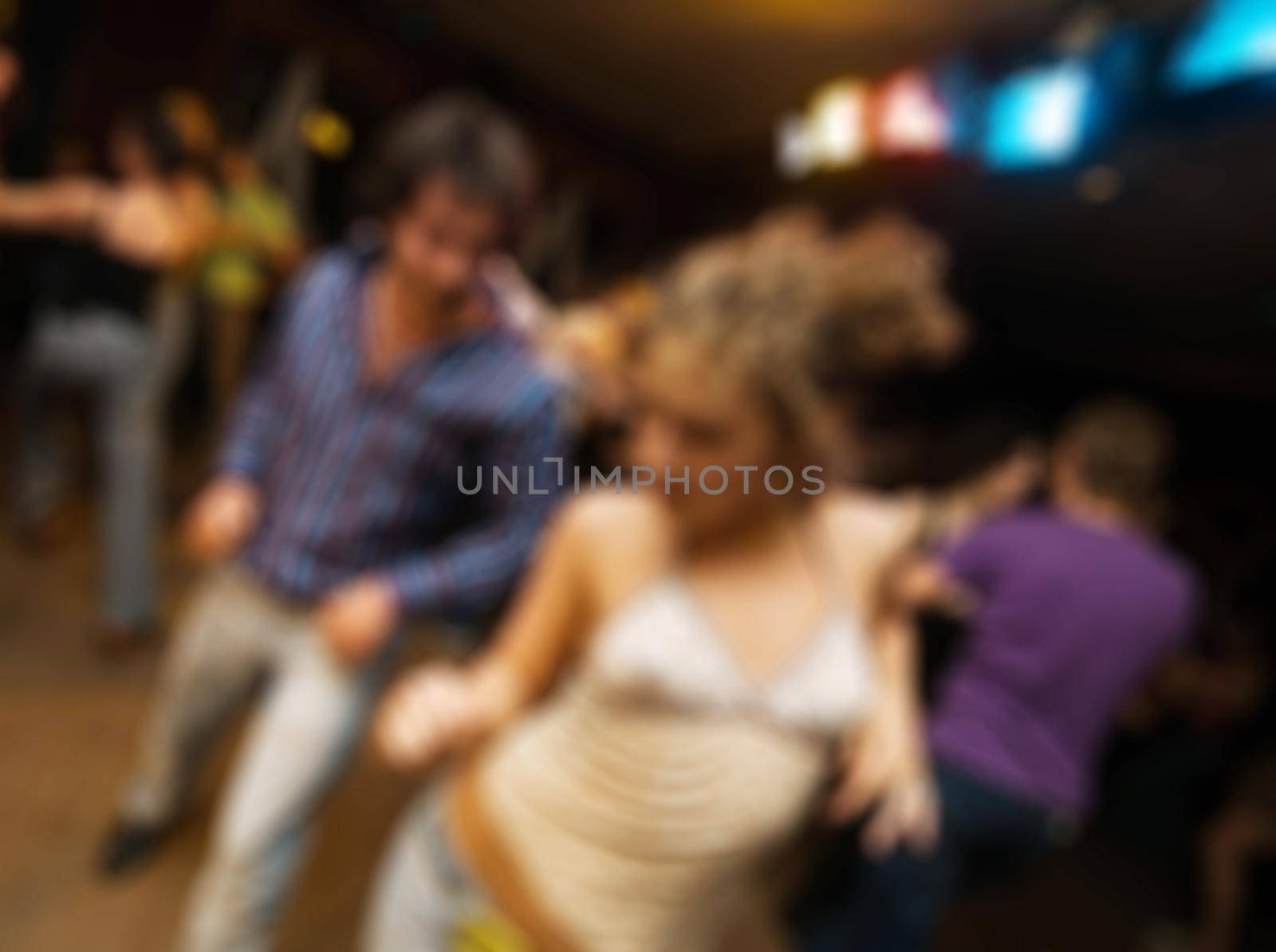 People dancing at the party abstract blur background with bokeh