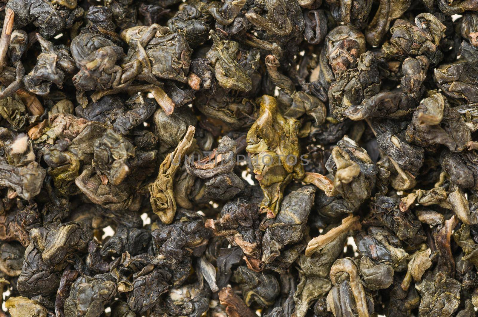 Heap of dry chinese green tea - background texture. Macro shot