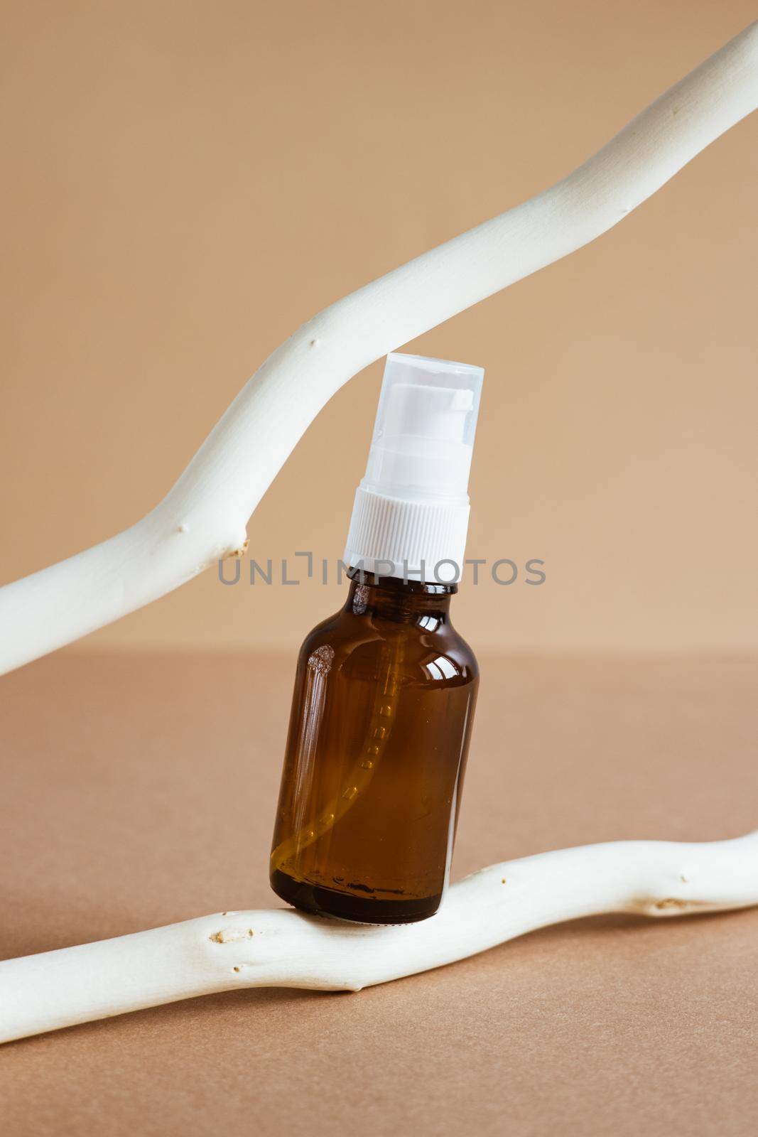 Brown glass bottle with a pipette on a wooden background, brown beige background copy space natural cosmetic concept by katrinaera