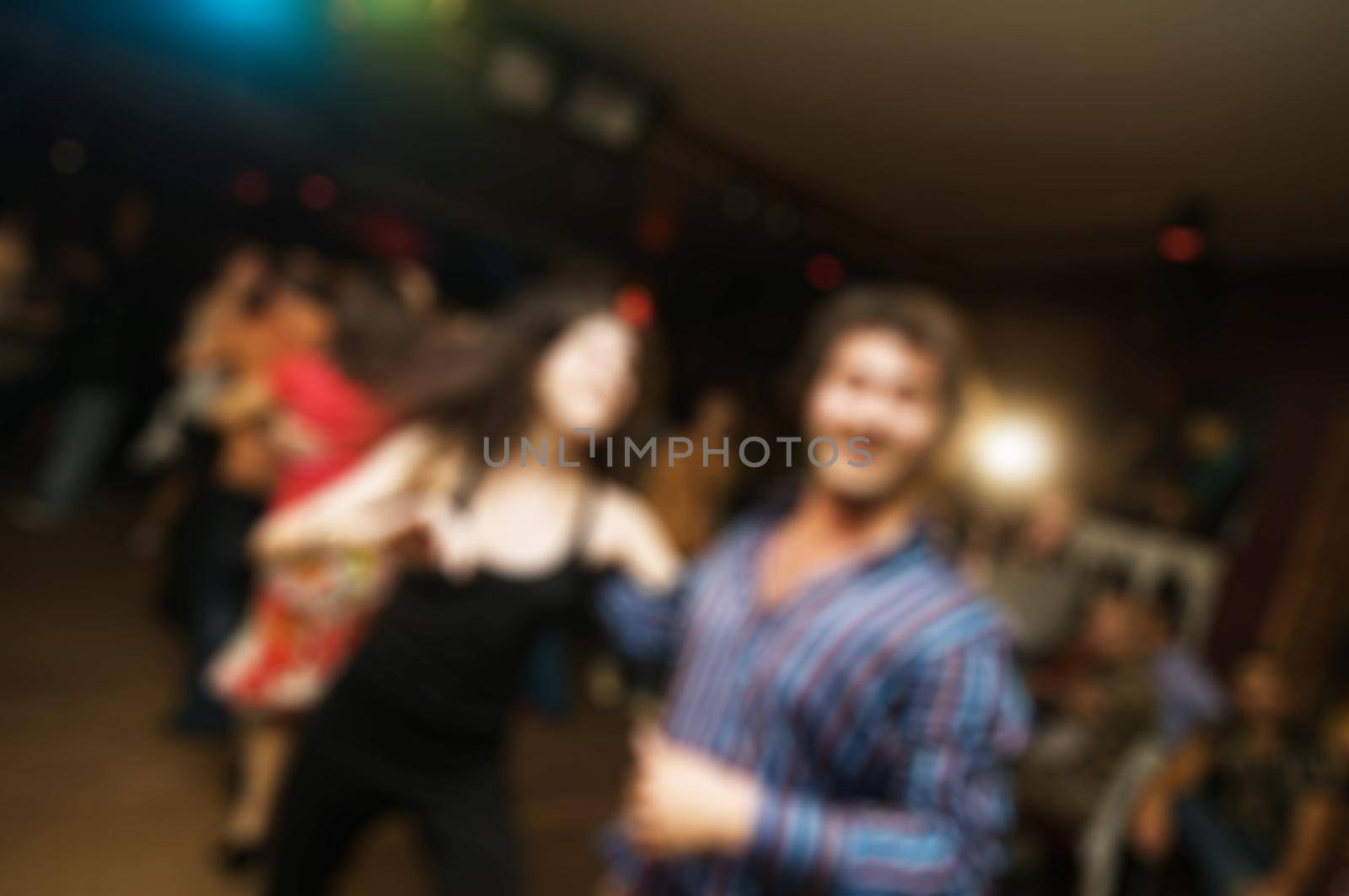 People dancing at the party abstract blur background with bokeh