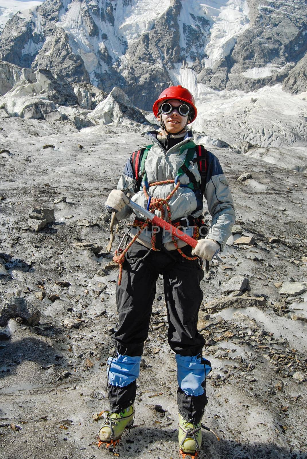 Young mountaineer is standing on a glacier during training courses