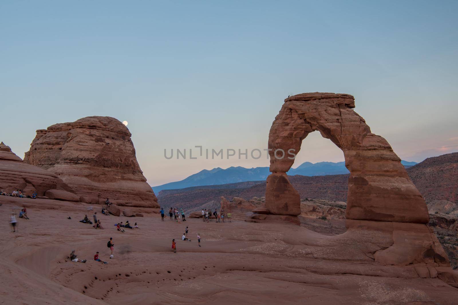 Delicate Arch in Arches National Park Utah at sunset with pastel sky. by jyurinko