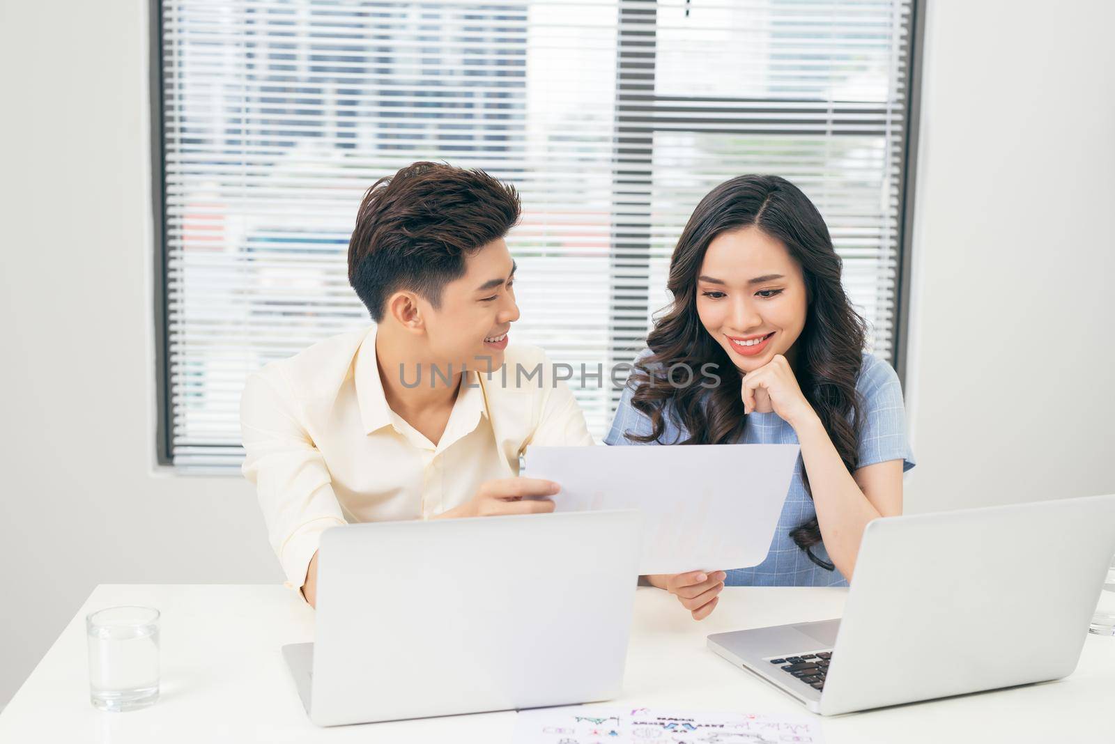 Young business team working together at a laptop, man and woman