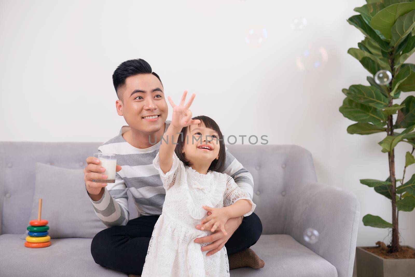 Father and daughter playing with bricks