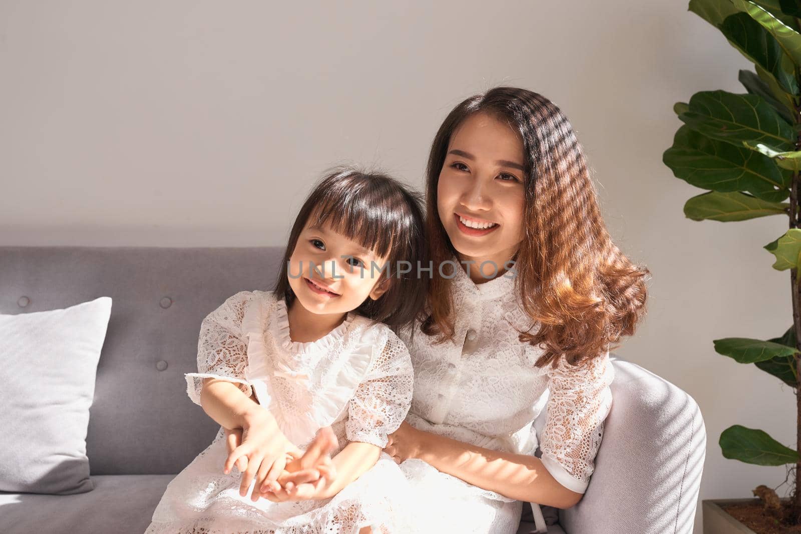 Happy young mother with daughter at home