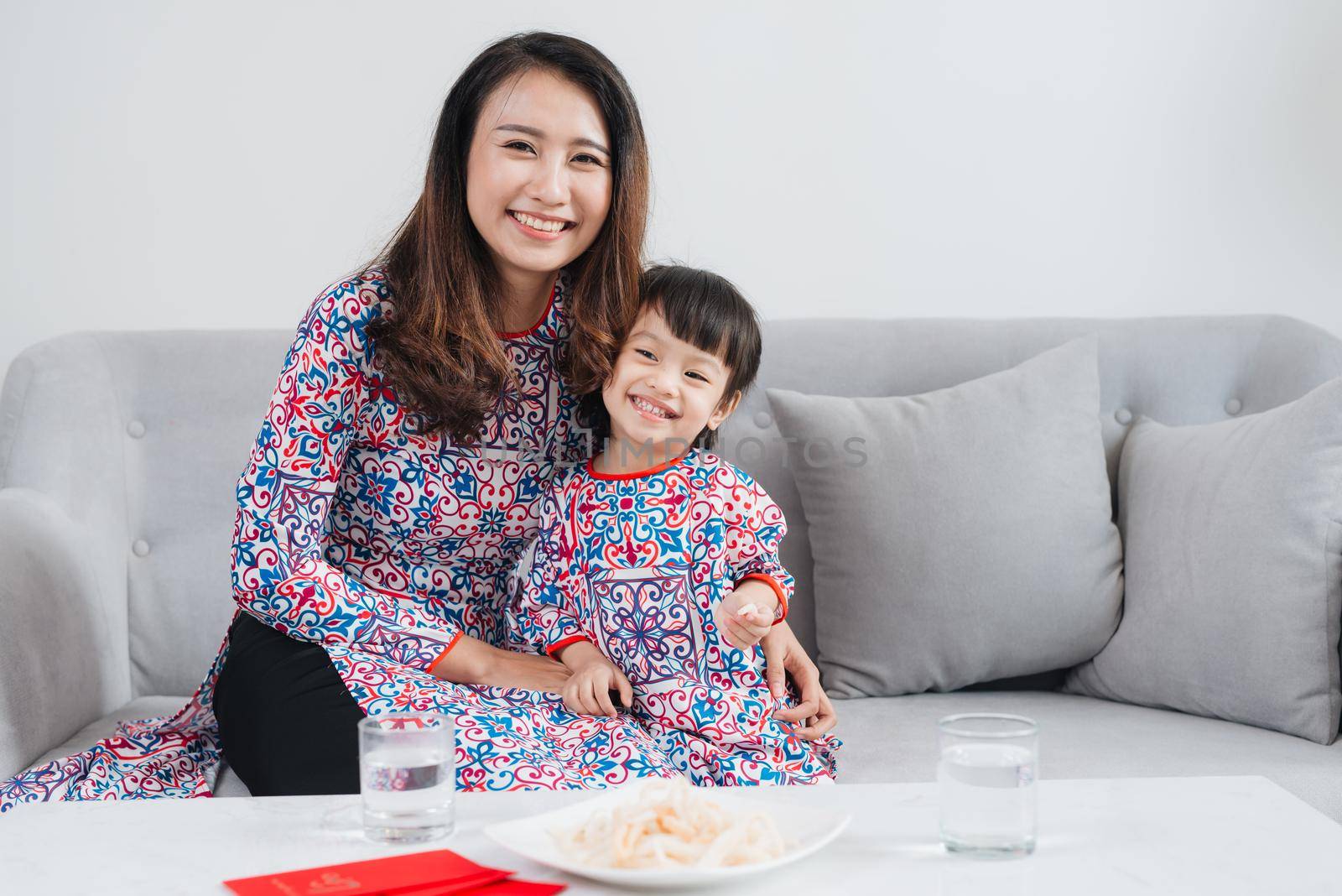 Vietnamese mother and daughter celebrate new year at home. Tet Holiday.