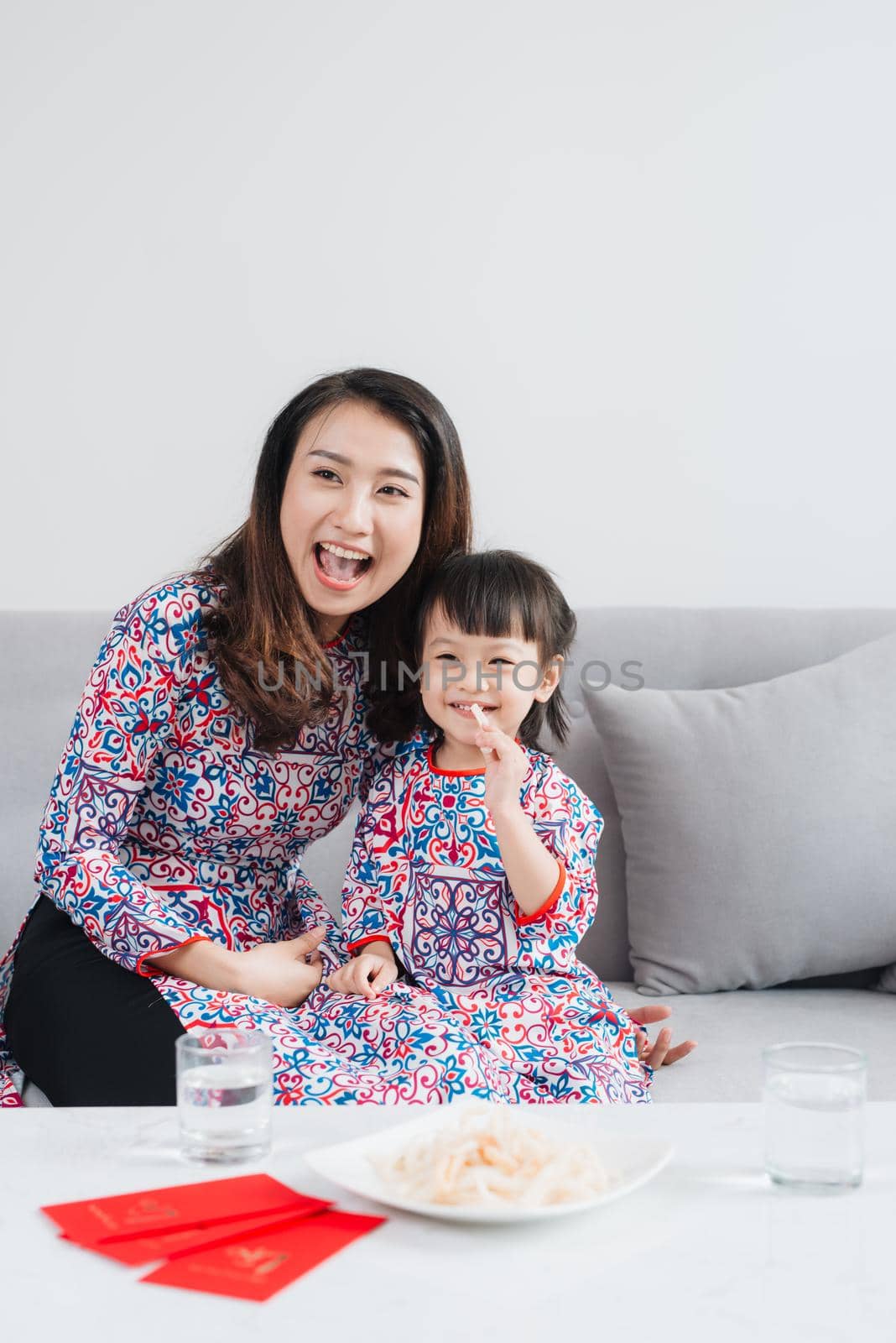 Vietnamese mother and daughter celebrate new year at home. Tet Holiday. by makidotvn