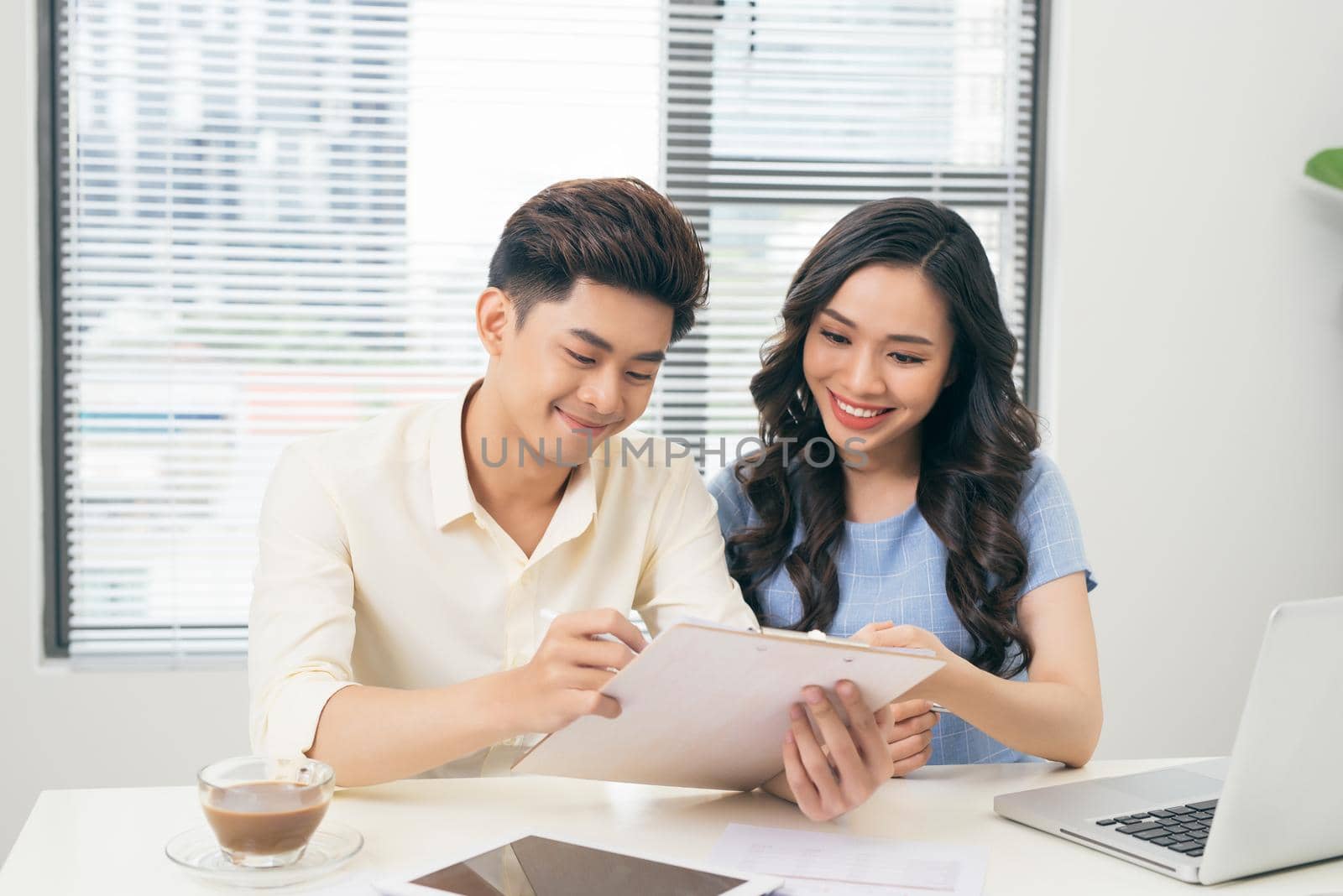 Business people working with computer and doing some paperwork while sitting at desk 