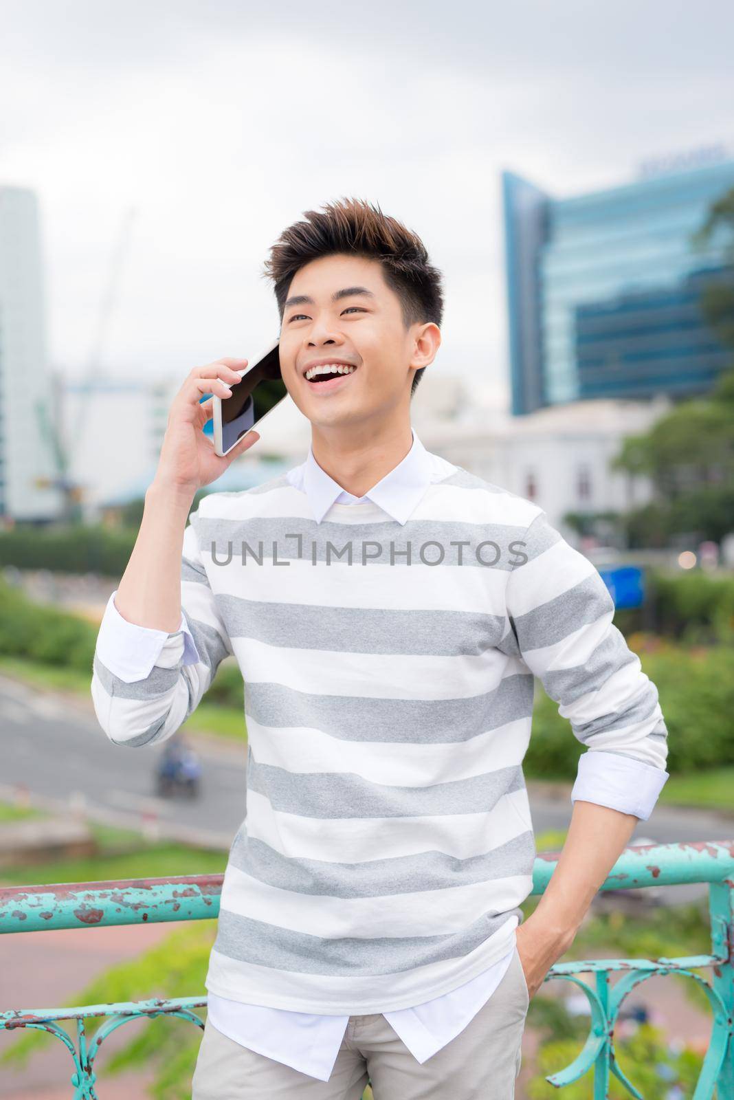 Portrait of a young male traveler talking on mobile phone