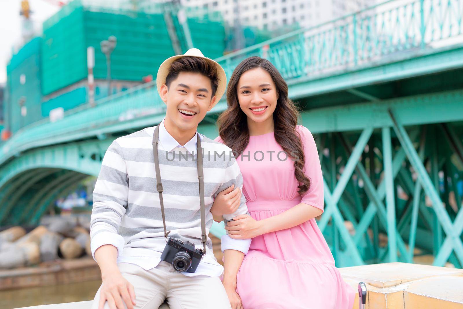 Young man and pretty girl are having fun in the city at evening.