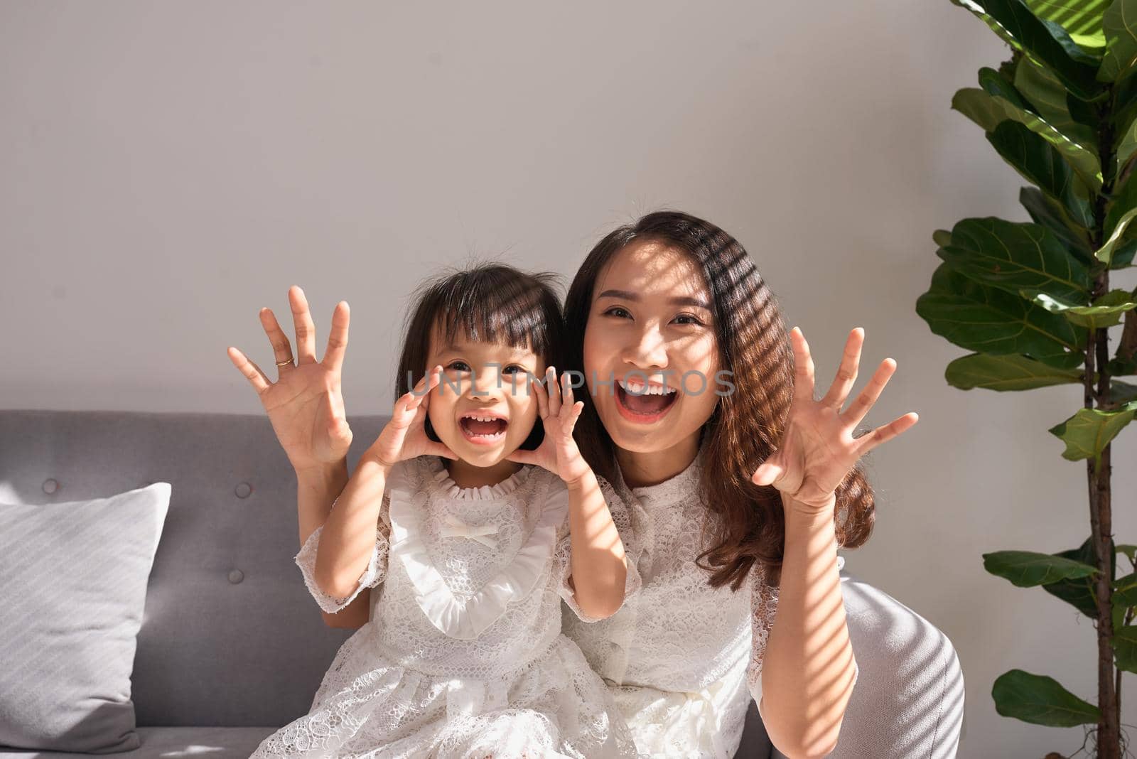 Happy young mother with daughter at home