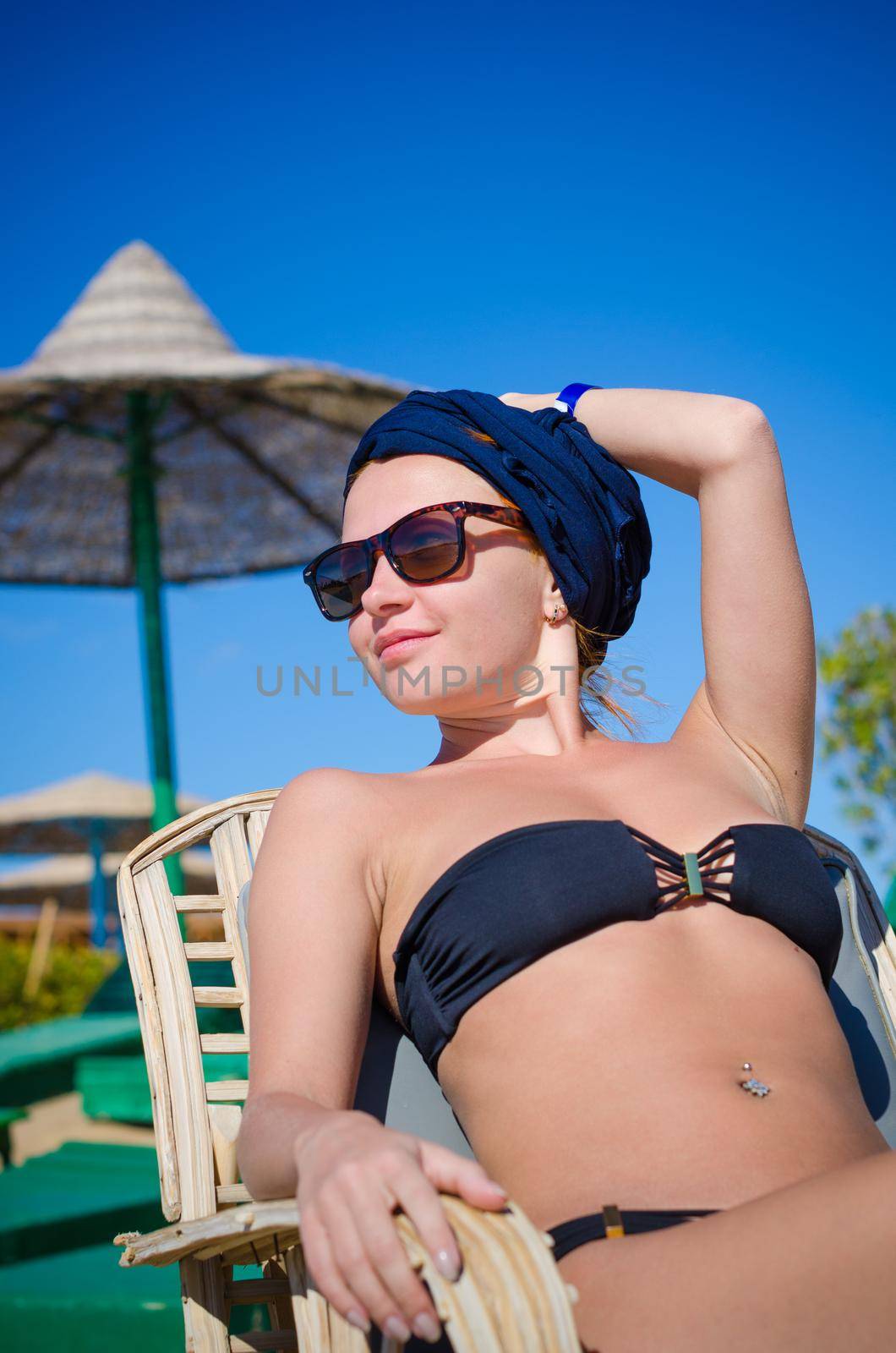 Young slim redhair woman enjoying sun at the beach in Egypt