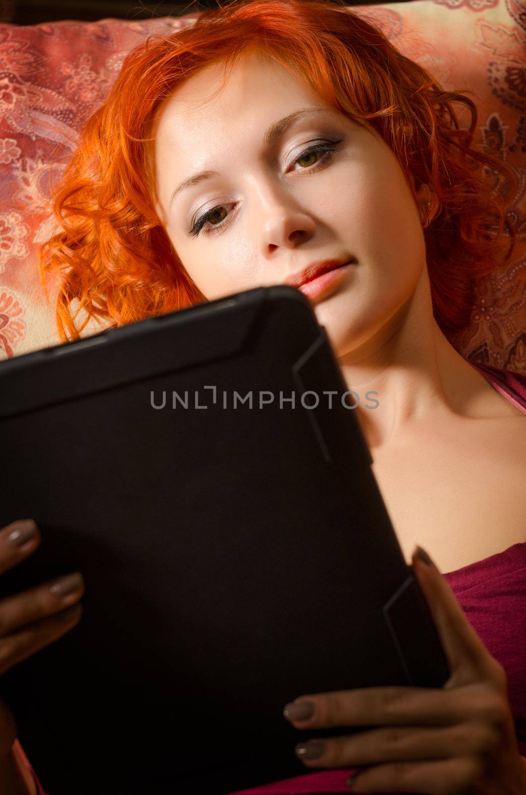 Young woman on a couch with tablet pc