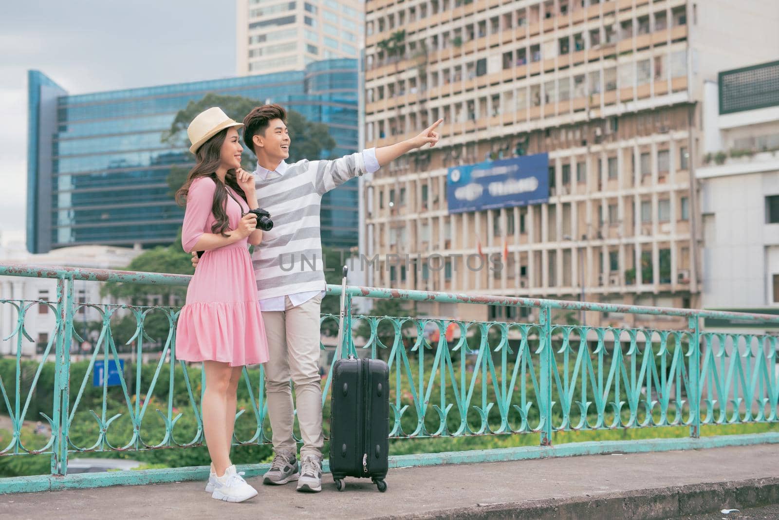 Young lovers walking around city on vacation, enjoying traveling together, outdoors.