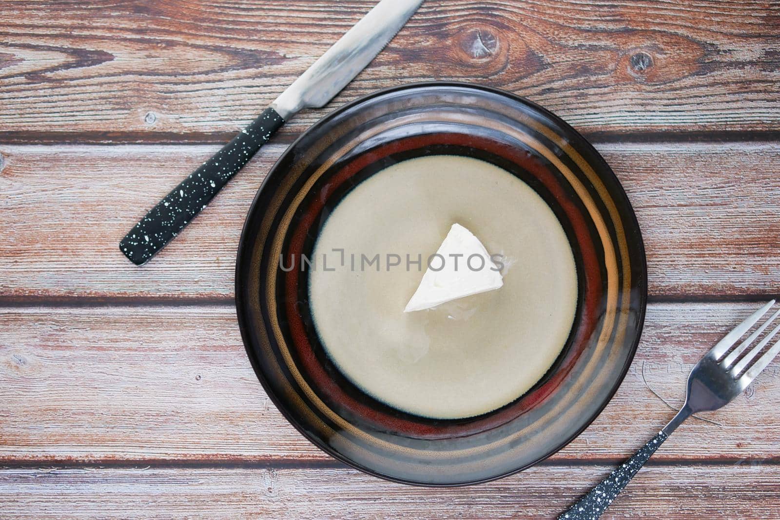 fresh cheese on a plate of on wooden background.,