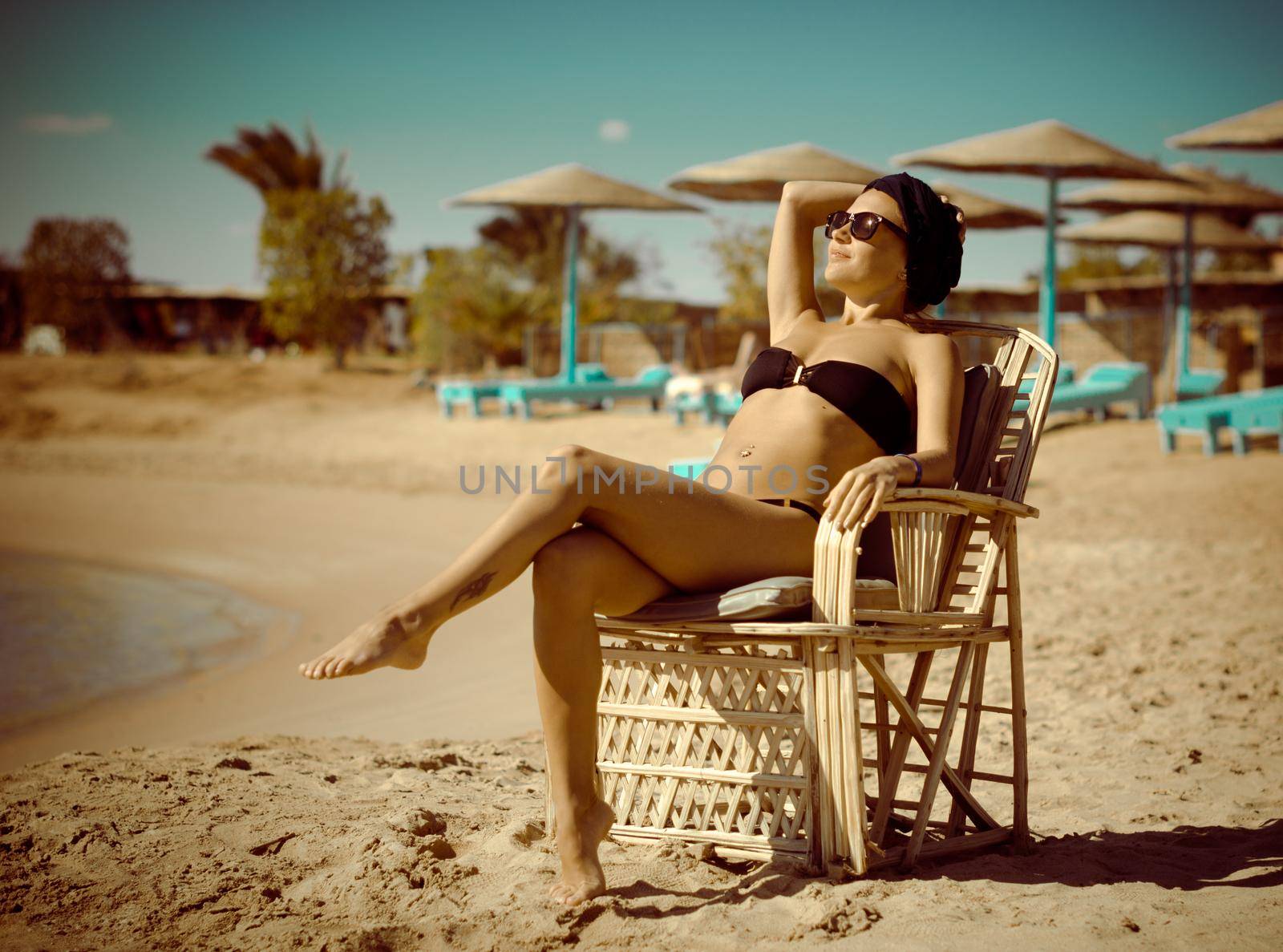 Young slim redhair woman enjoying sun at the beach in Egypt