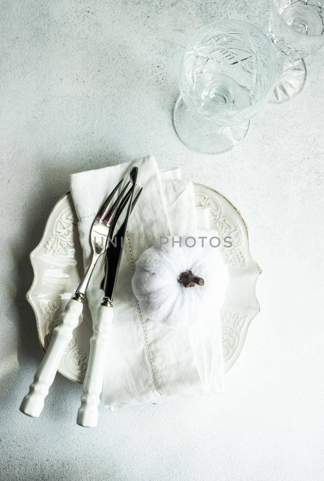 Autumnal table setting with white textile pumpkin