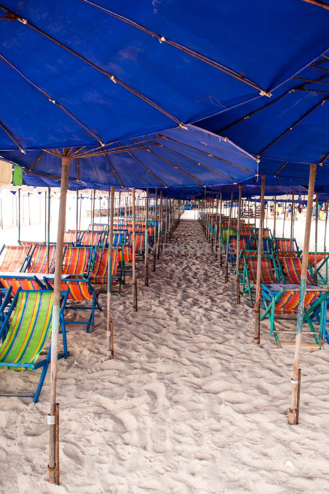 Colorful canvas daybed under the beach umbrella